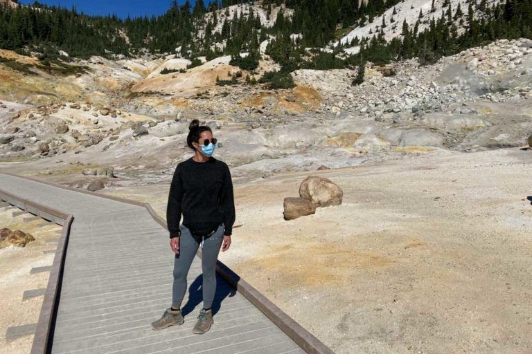 Bumpass Hell hiker on boardwalk wearing face mask in 2020, Lassen Volcanic National Park