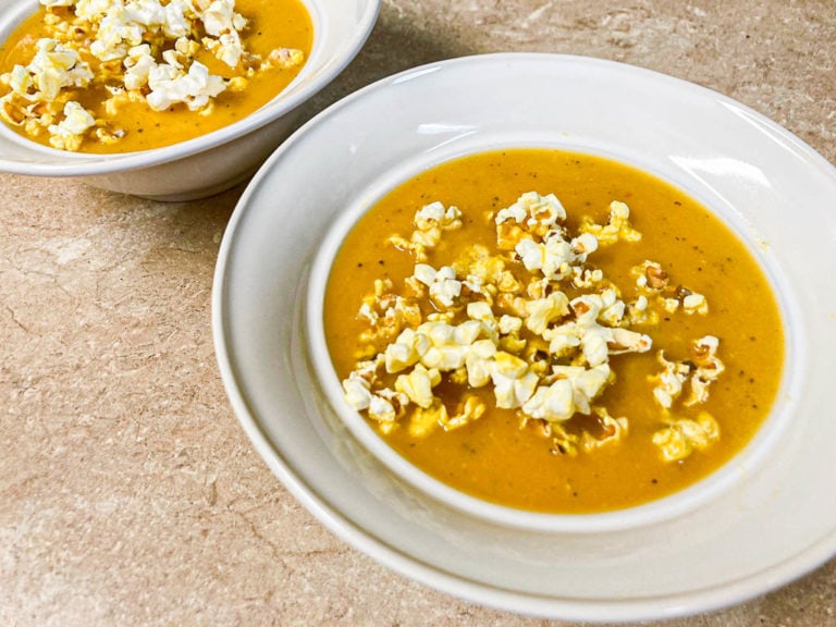 Butternut squash soup with popcorn in bowl