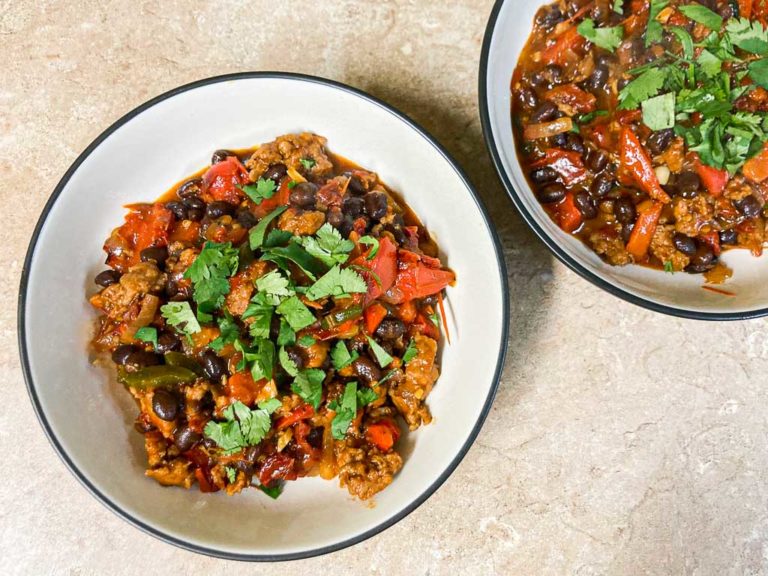 Chorizo, black beans and roasted bell pepper skillet dish in bowls