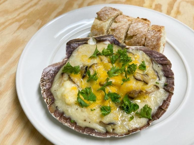 White fish gratin in seashells recipe with toasted sliced baguette