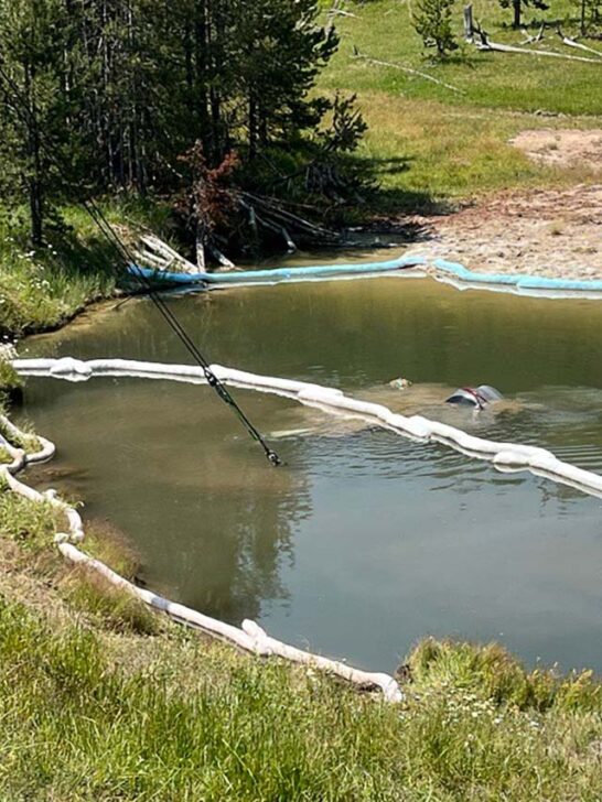 Crew lifts submerged car out of thermal feature in Yellowstone National Park - Image credit NPS