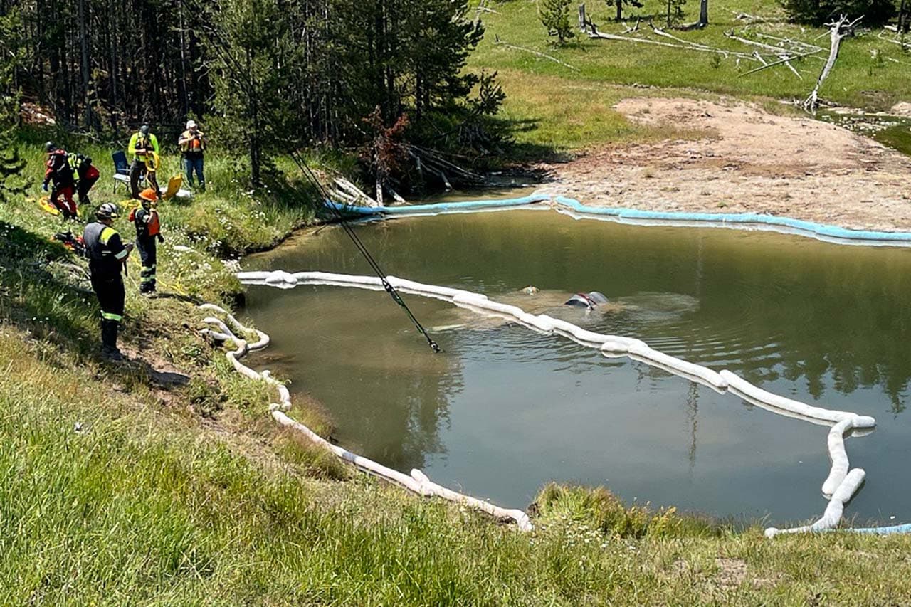 Crew lifts submerged car out of thermal feature in Yellowstone National Park - Image credit NPS